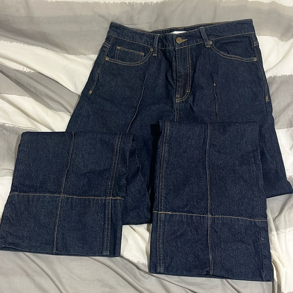 Wide leg dark wash denim jeans with front seam